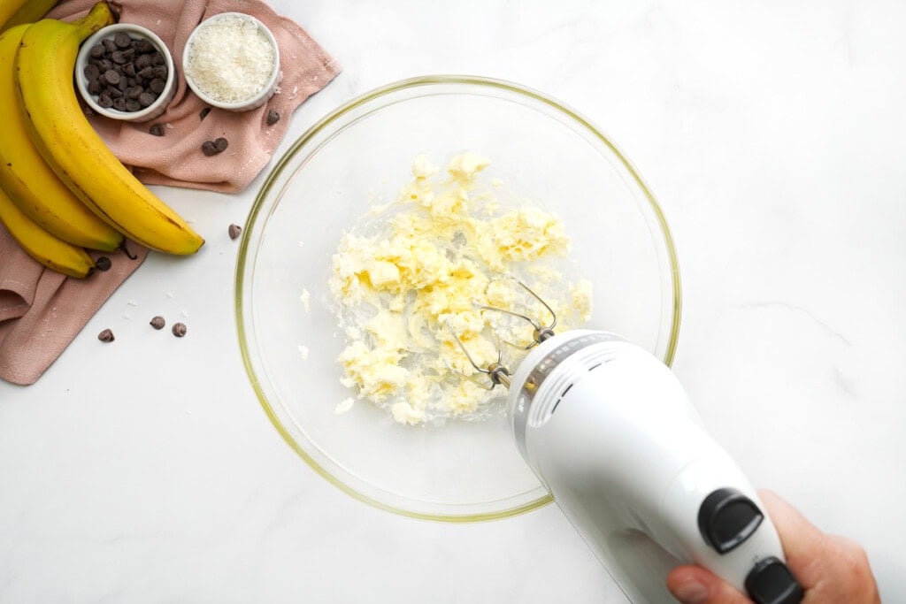 Creaming butter with electric mixer.