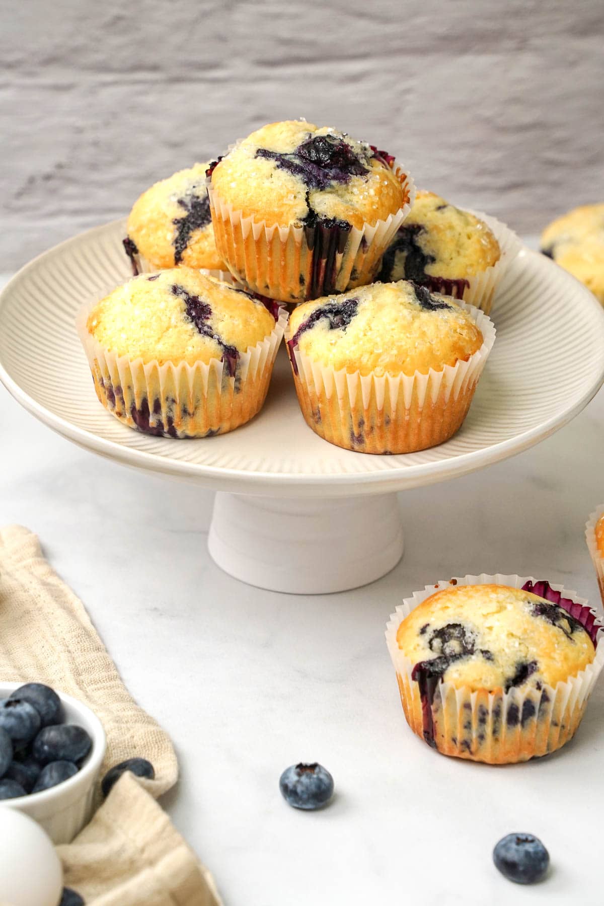 Easy Blueberry Muffins stacked on stand.