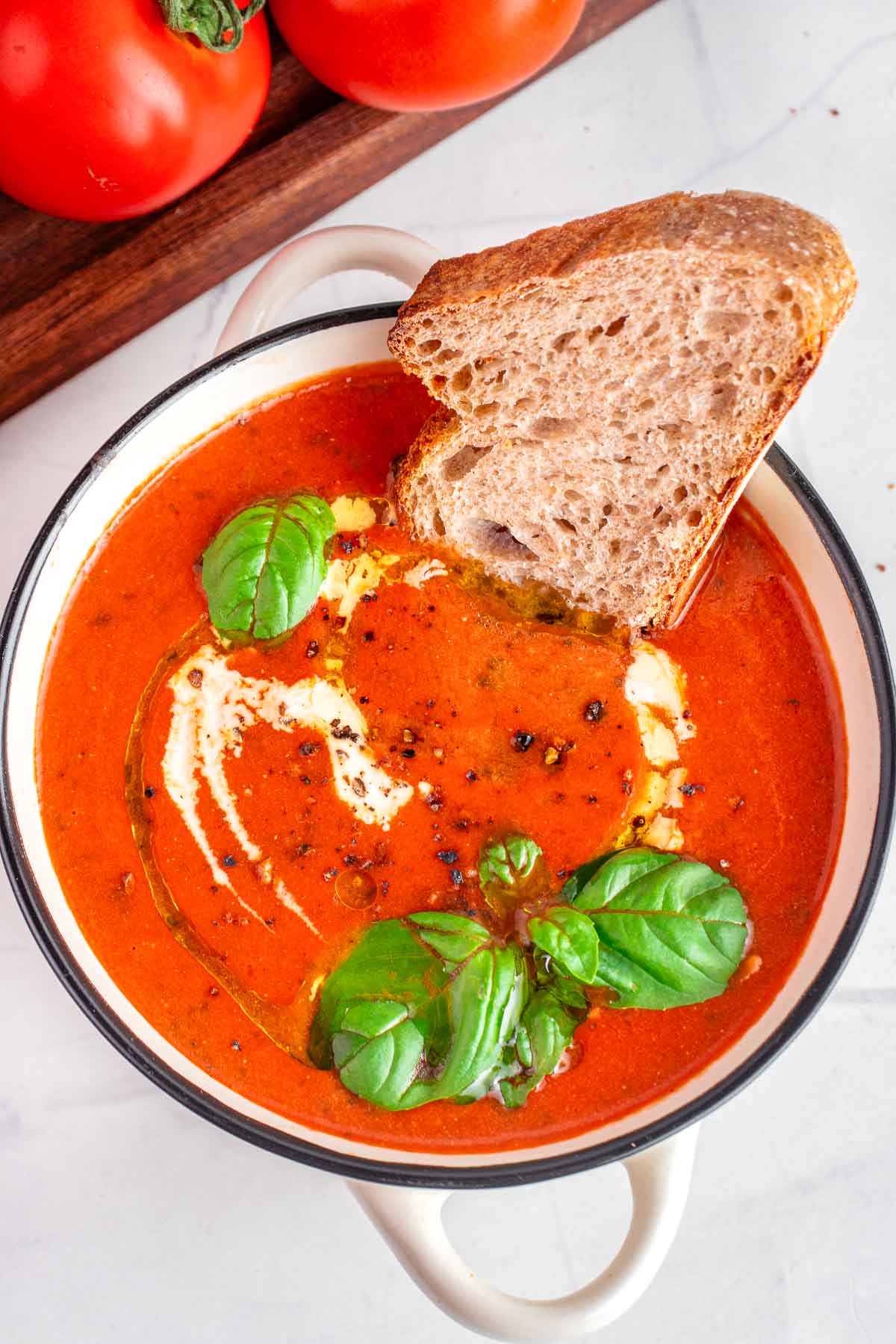 Easy Tomato Soup recipe with bread dunked in it.