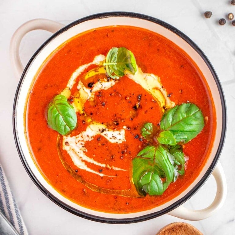 Easy Tomato Soup recipe, aerial view garnished in pot.