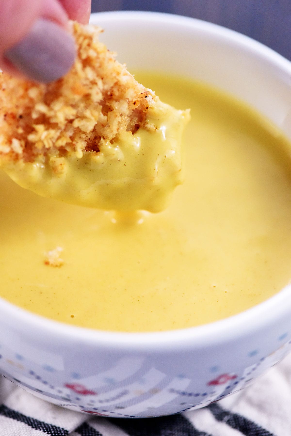 Honey Mustard Dipping Sauce with chicken nugget being dipped.