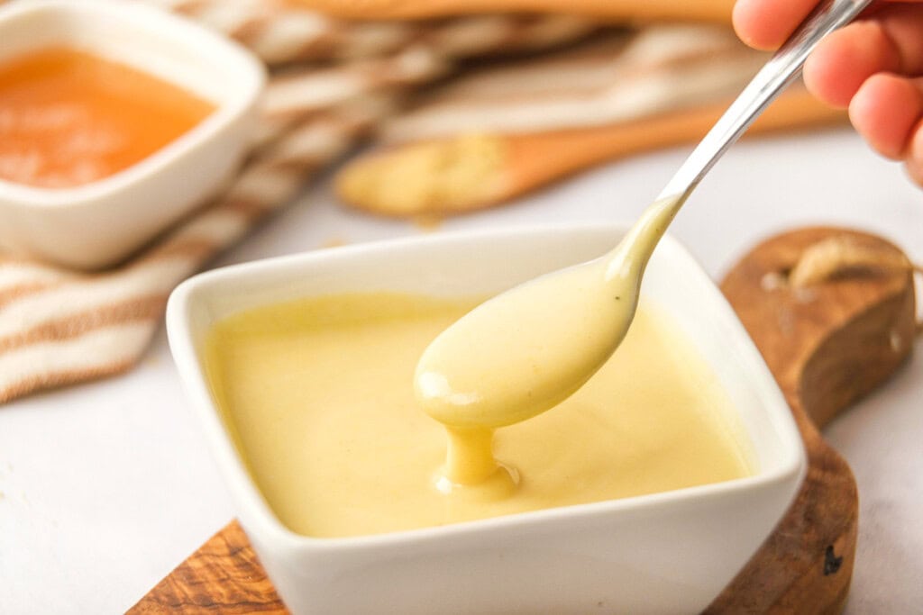 Honey Mustard Dipping Sauce drizzling off of spoon.