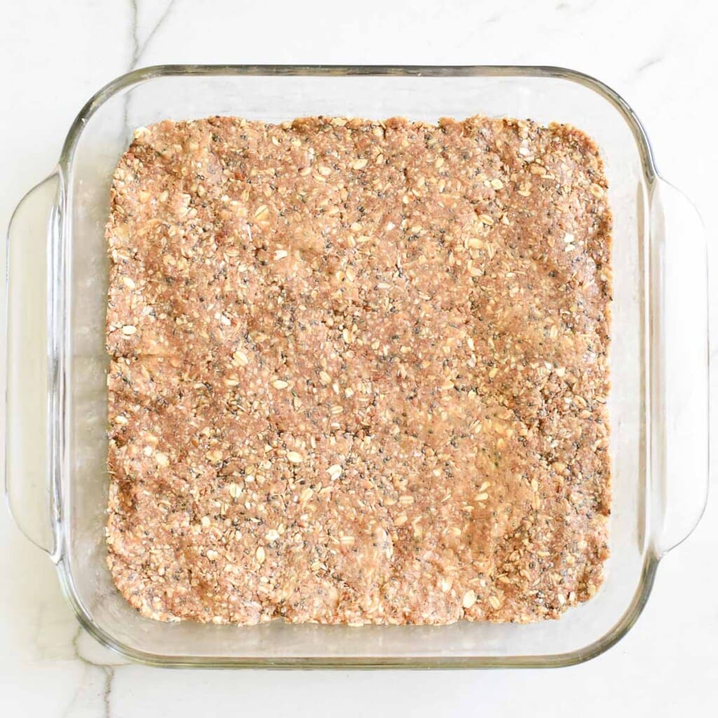 Protein bars recipe pressed into dish.