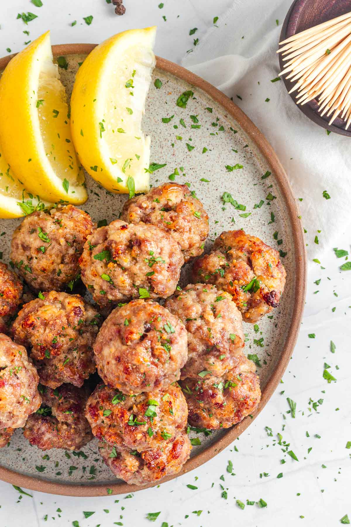 Baked Turkey Meatballs with lemon wedges.