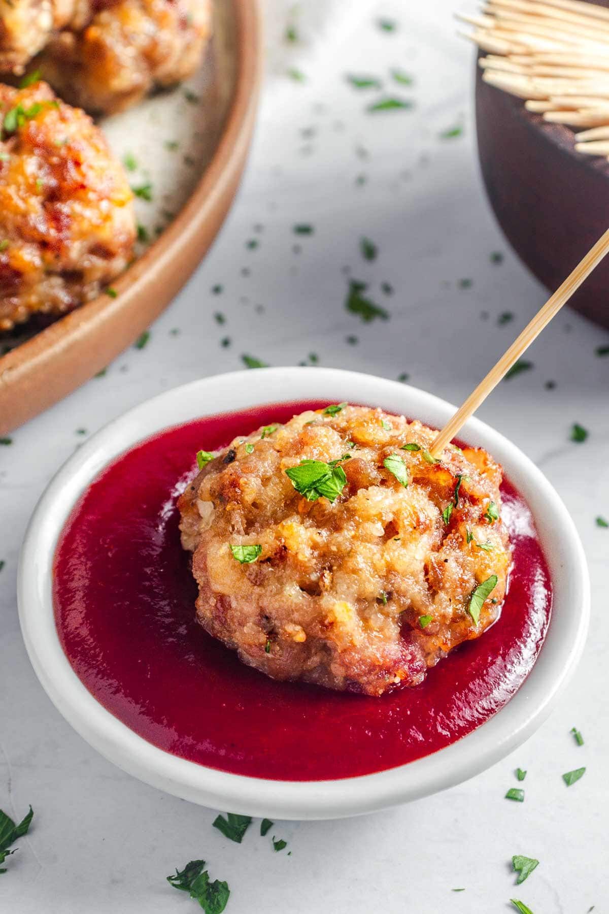 Baked Turkey Meatballs dipped in bbq sauce.