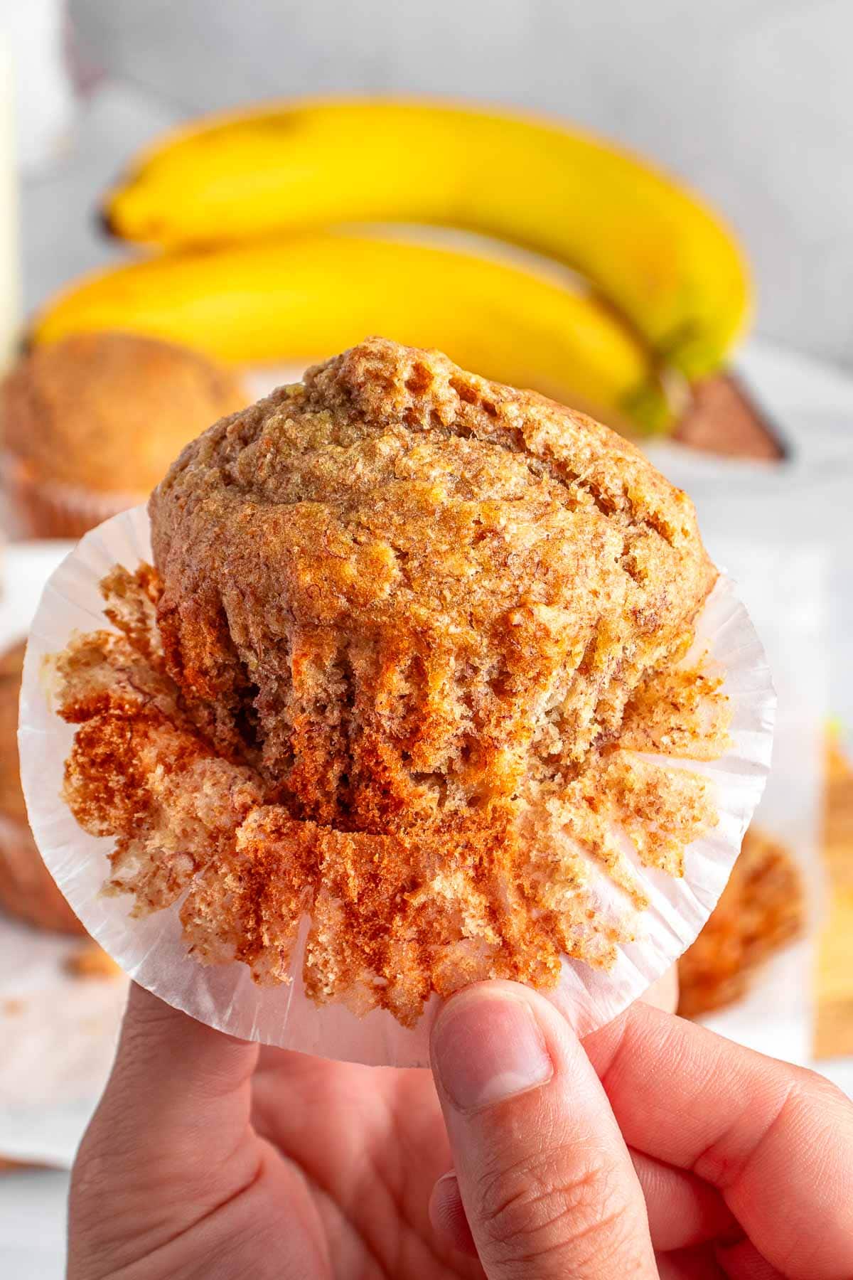 Healthy Banana Muffins being removed from muffin liner.