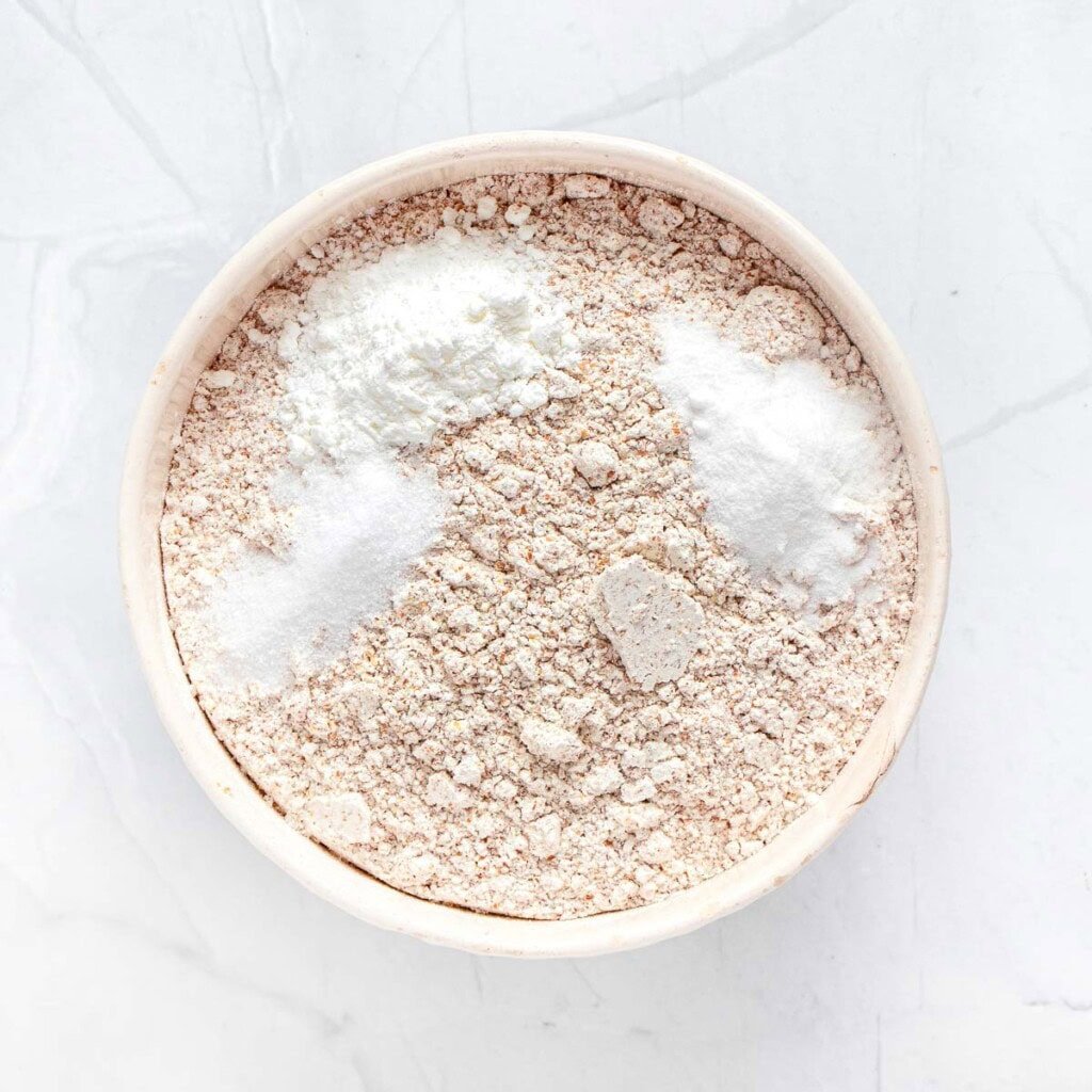 Whole wheat flour and other dry ingredients in bowl.