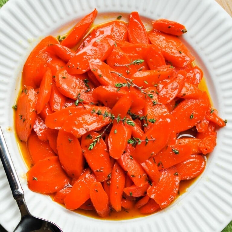 Honey Glazed Carrots with lemon and thyme aerial on plate.