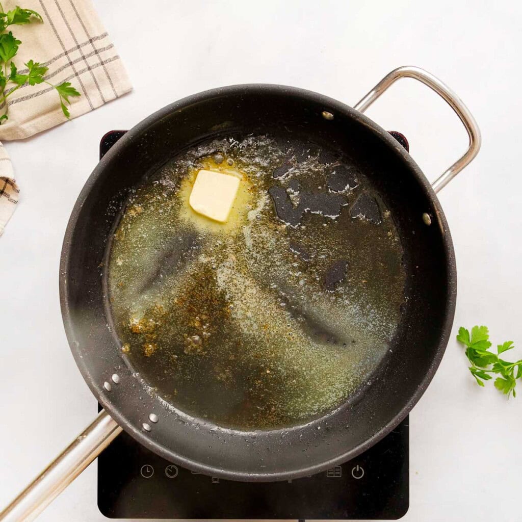 Adding more butter to skillet.