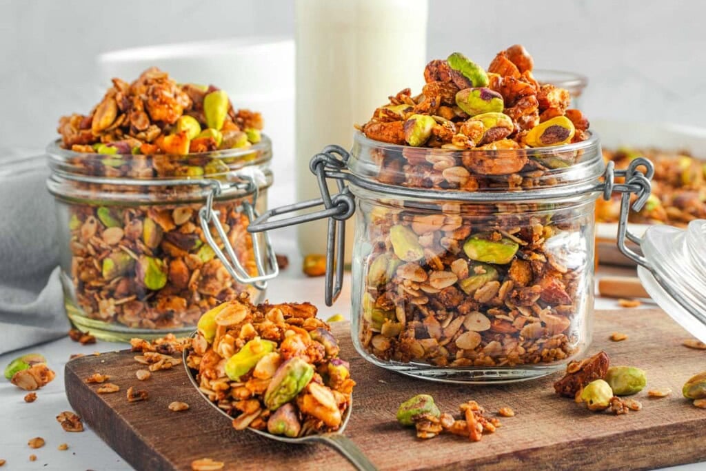 High Protein Granola recipe in jars and in spoon.