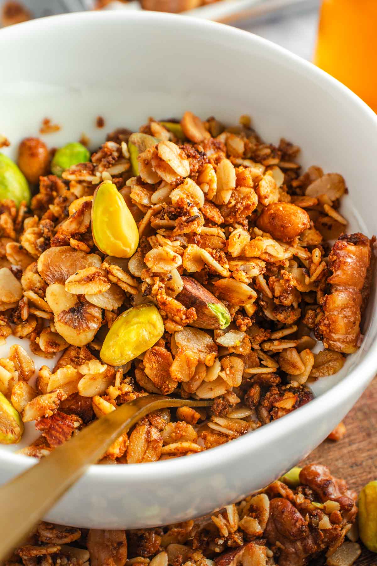 High Protein Granola in bowl with spoon and Greek yogurt.