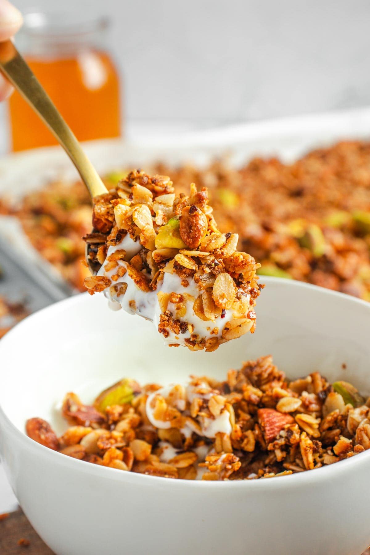 Protein Granola with yogurt on spoon.