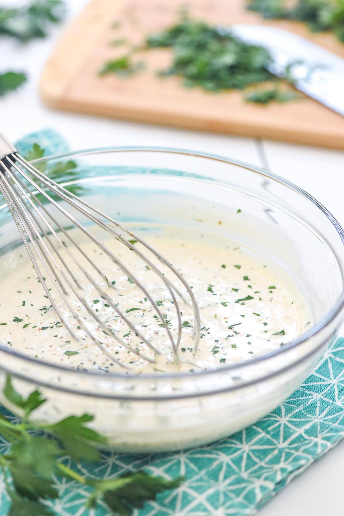 Homemade ranch dressing recipe in bowl with fresh parsley.