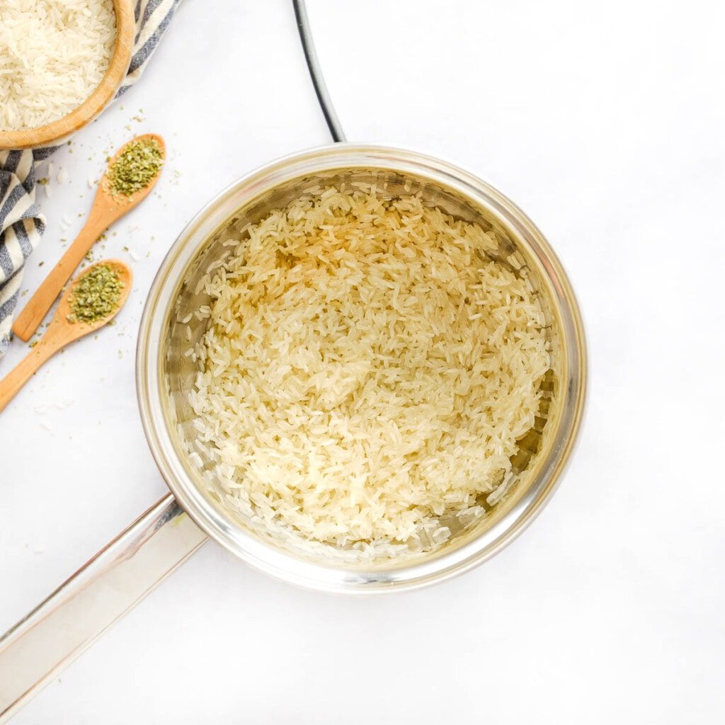 Toasting white rice in pot.