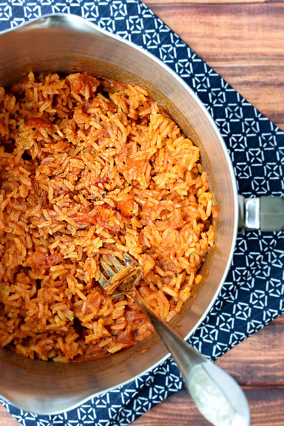 Spanish rice being fluffed with a fork.