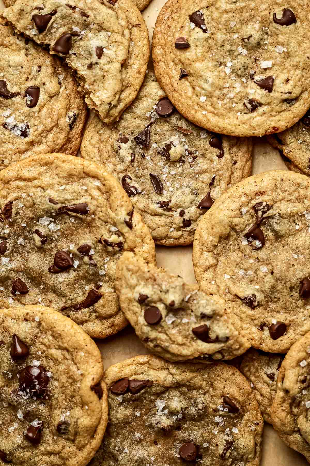 Brown Butter Chocolate Chip Cookies layered on parchment paper.