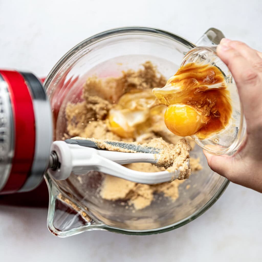 Adding eggs to Brown Butter Chocolate Chip Cookies recipe.