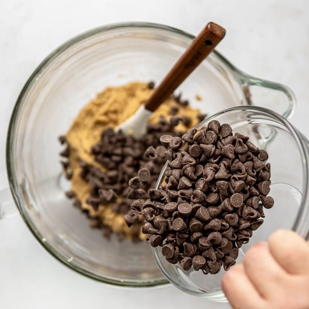 Adding chocolate chips to Brown Butter Chocolate Chip Cookie recipe.