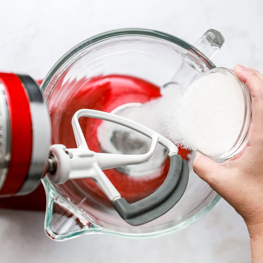 Adding sugar to bowl.