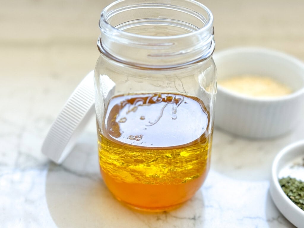 Oil, vinegar, lemon juice, water, and honey for Homemade Italian Dressing.